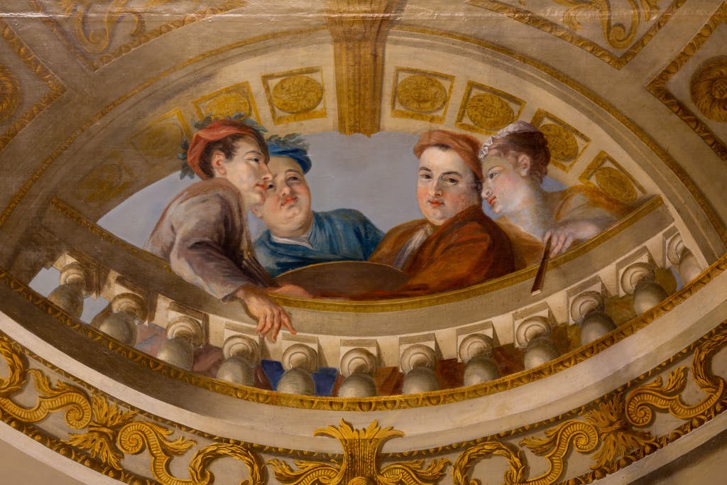 A mural on a ceiling depicting four male figures talking while one stares at the viewer