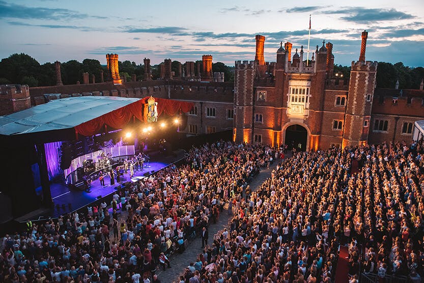 A music festival takes place in front of a huge crowd within the Tudor courtyard of Hampton Court Palace