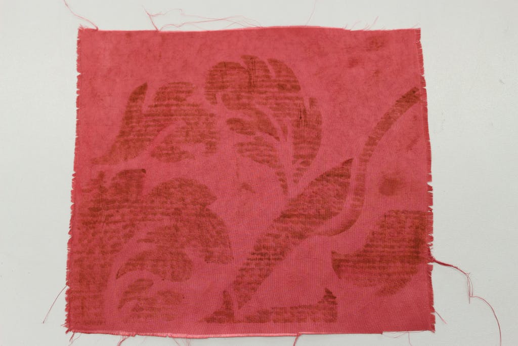 Conservation of Queen Caroline's State Bed. Showing a close view of a sample of the finished patch design on taffeta for the original damask.