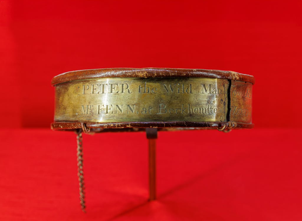 A brass collar with text inscribed on the outside