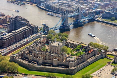 Aerial view of the Tower of London from the north west with Tower Bridge in the distance.