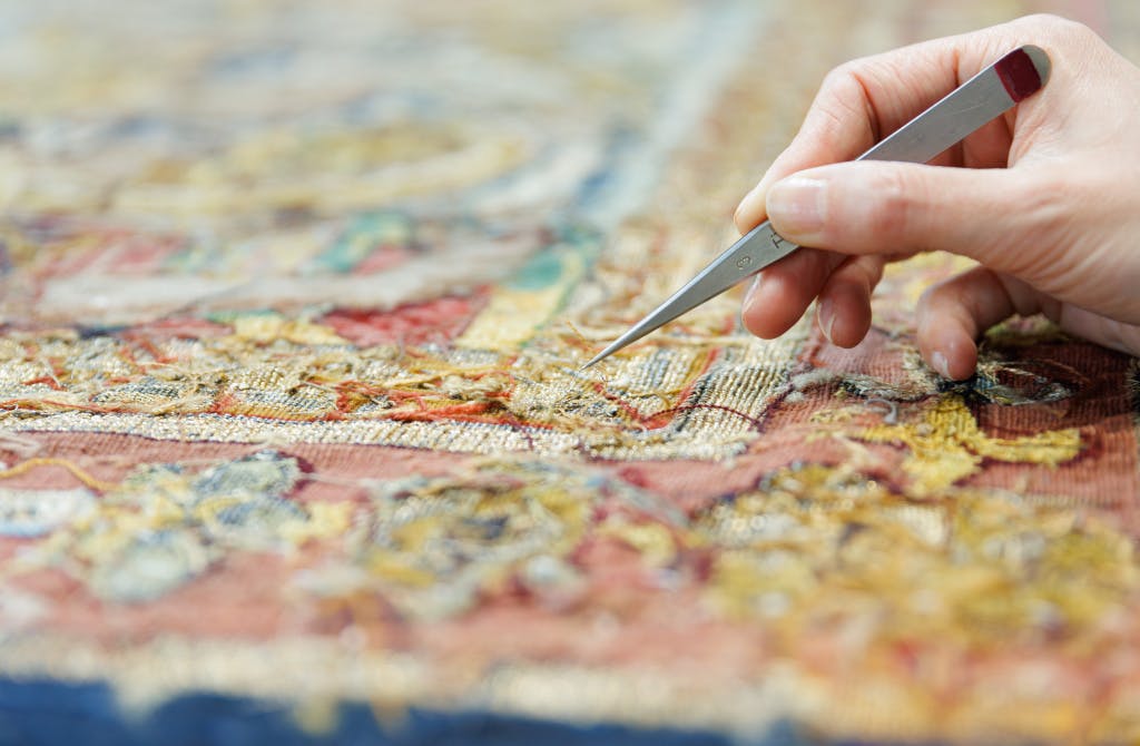 A large tapestry in a conservation studio