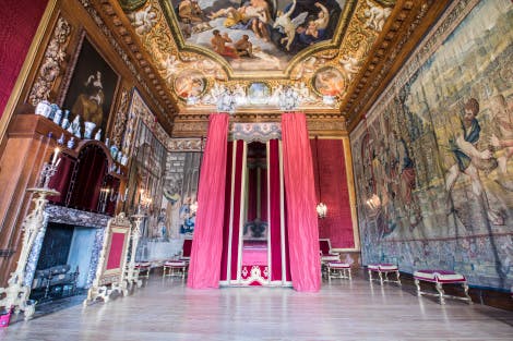 The King's Great Bedchamber, looking north. 

Objects seen include the state bed (1716) carved by Richard Roberts (active 1714-29), "Purchase of the Field of Ephron" wall tapestry attributed to Pieter Coeck van Aelst (1502-50) (on the right of the image), also showing part of the ceiling painting (c1701) by Antonio Verrio (c. 1639-1707).