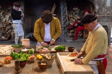 Historic cooks preparing food in Henry VIII's Kitchens
