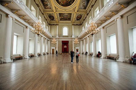 Photograph of visitors in the main hall of the Banqueting House