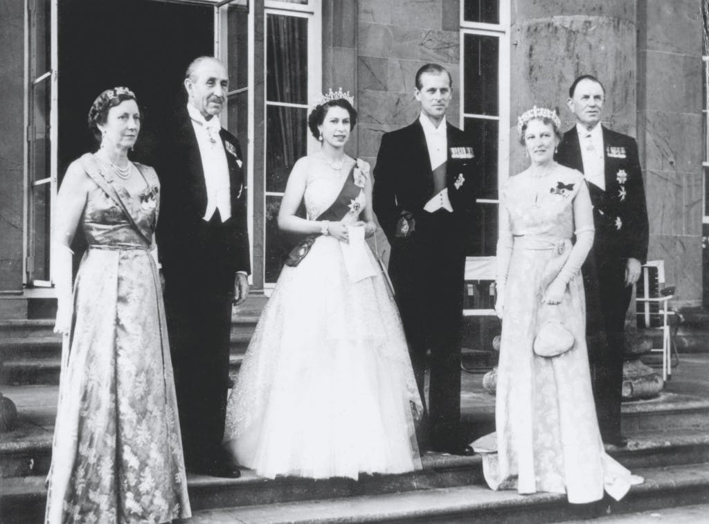 State dinner for Queen after arrival in Northern Ireland . The Queen and the Duke of Edinburgh , standing on the steps of Government House after attending a reception there following their arrival at Hillsborough on a three-day State visit to Northern Ireland. At left are Landy Brookeborough and Lord Brookeborough , Prime Minister of Northern Ireland . Lord Wakehurst , the Governor and Lady Wakehurst are on right . 2 July 1953.