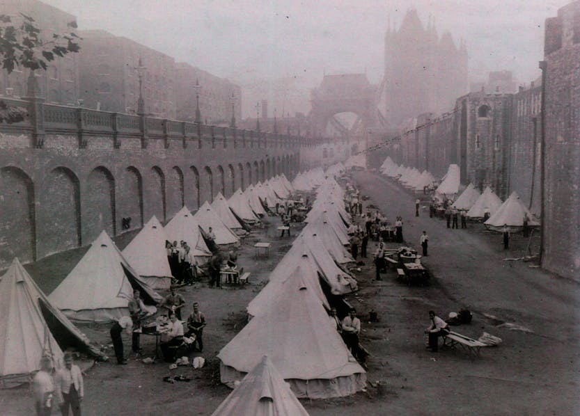 Soldier encampment in the east moat, with a distant view of Tower Bridge. The moat was used for encampment on many occasions; these may have been the quarters of soldiers required for Queen Victoria's Diamond Jubilee celebrations of 1897.