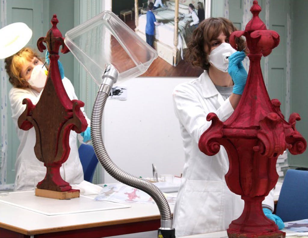 Working on the bed’s finials in the conservation studio