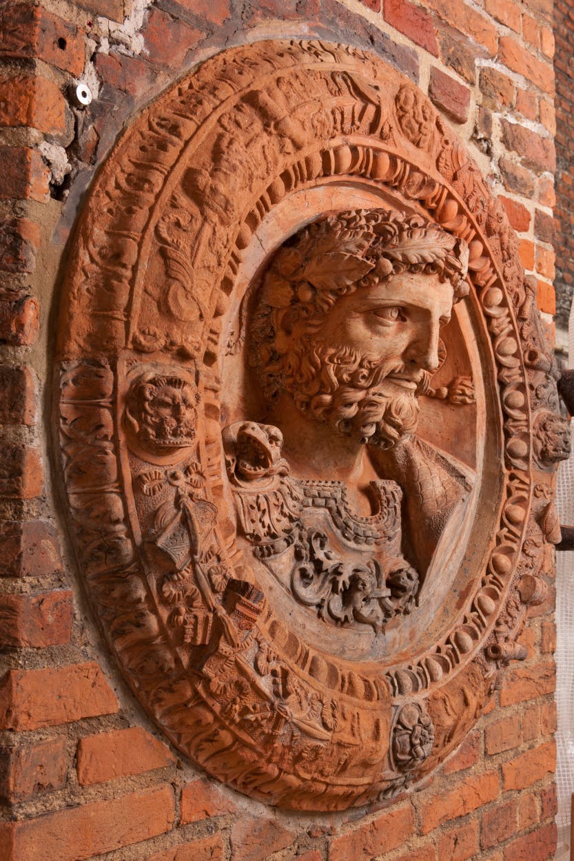 Anne Boleyn's Gateway, showing a close view of the 16th century terracotta roundel Hadrian, after conservation.