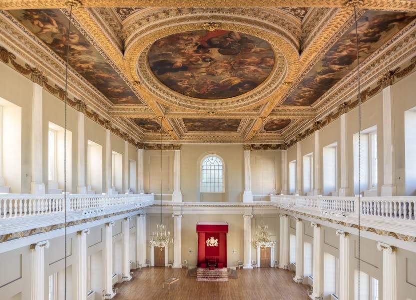 Banqueting House great hall in Whitehall with the throne at the far end of the room, and Rubens decorative painted ceiling above.