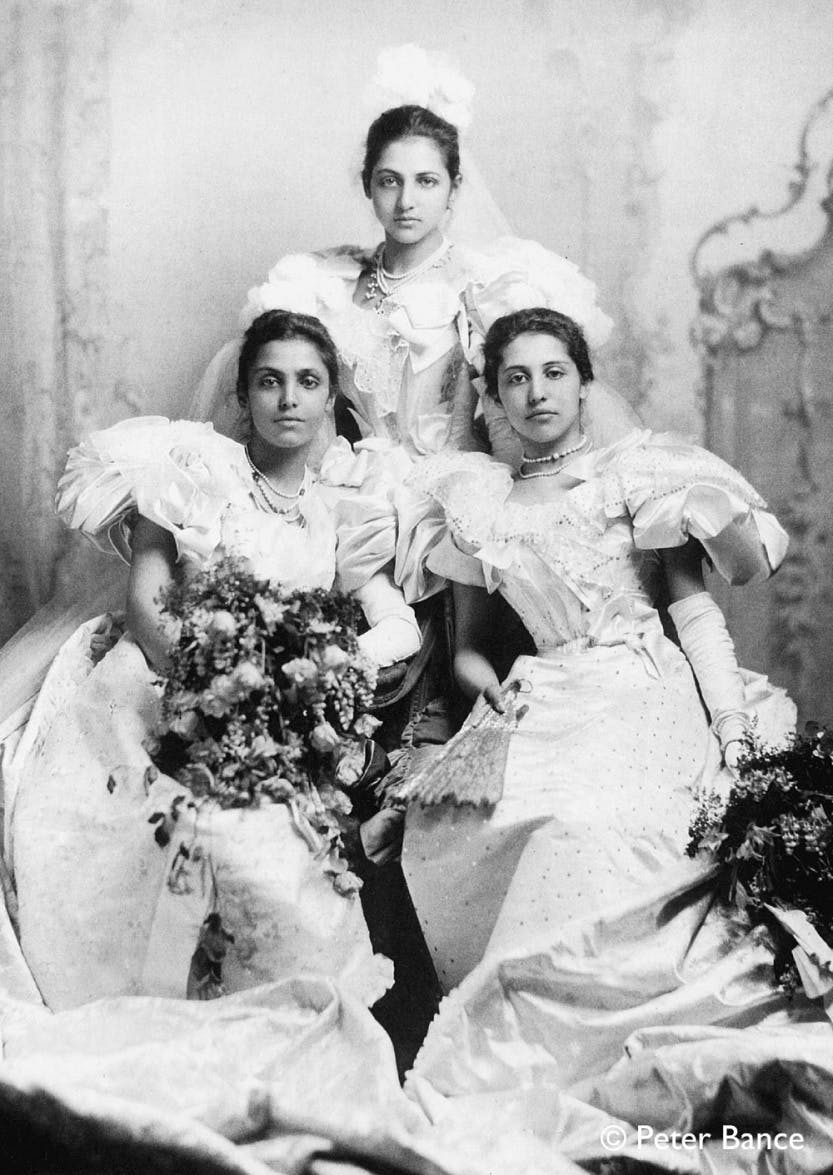 Sophia, Catherine and Bamba Duleep Singh at the 1895 Debutants Ball. Showing the three princesses posing in white dresses and holding bouquets of flowers.