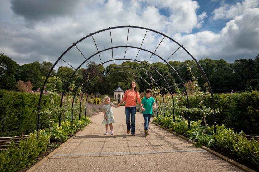 A mother and two children enjoy exploring the Walled Garden of Hillsborough Castle and Gardens