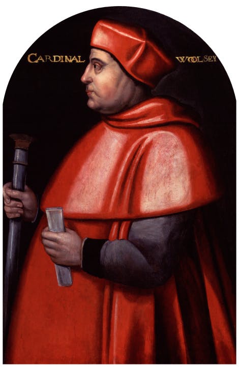 A man standing in side profile in the red hat and robes of a cardinal