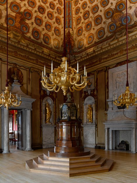 The Cupola Room, looking south east, showing William Kent's painted decoration of the walls and ceiling and an 18th-century musical clock the 'Temple of the Four Great Monarchies of the World'
This room was the principal state room of the palace. It was here that Princess Victoria (later Queen) was christened in 1819.