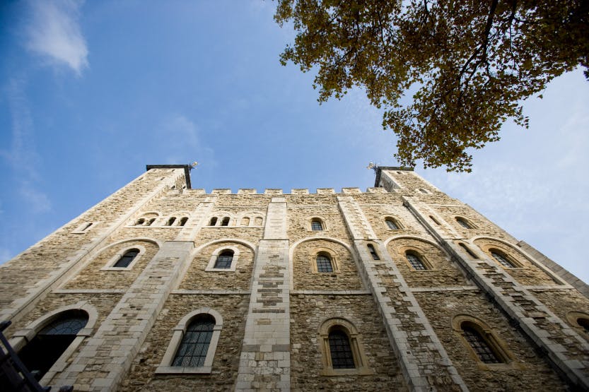 A low angle view of the White Tower framed against a blue sky. Looking north, October 2009.

The White Tower was begun in the reign of William the Conqueror (1066-87) and completed by 1100. The fortress was originally faced with huge blocks of pale marble-like Caen stone imported from Normandy. In 1636-8 the external appearance of the White Tower was significantly altered with the replacement of much of its cut-stone work and window surrounds with Portland stone. 

The primary role of the White Tower was as a fortress and stronghold but it also served as a royal residence and as the setting for major governmental and ceremonial functions.