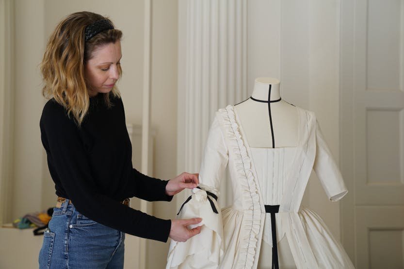 Libby Thompson with her toile inspired by Oliver Messel, who created a 18th century-inspired costume for Princess Margaret.