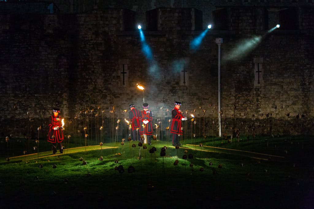 The Tower Moat, showing Yeoman Warders including (L-R) Amanda Clark, Chris Skaife and Jason Woodcock fulfilling their ceremonial duty at the "Beyond the Deepening Shadow" public event. 

“Beyond the Deepening Shadow: The Tower Remembers” was a public act of remembrance to commemorate the centenary of the end of the First World War.

Each evening from 4 to 11 November 2018 the Tower moat was illuminated by 10,000 individual flames. The artistic installation included an exploration in sound of wartime alliances, friendship, love and loss. Beginning with a procession led by the Yeoman Warders, Armistice torches were lit to form a circle of light radiating from the Tower. A symbol of remembrance for the hundreds of thousands who died in the Great War.