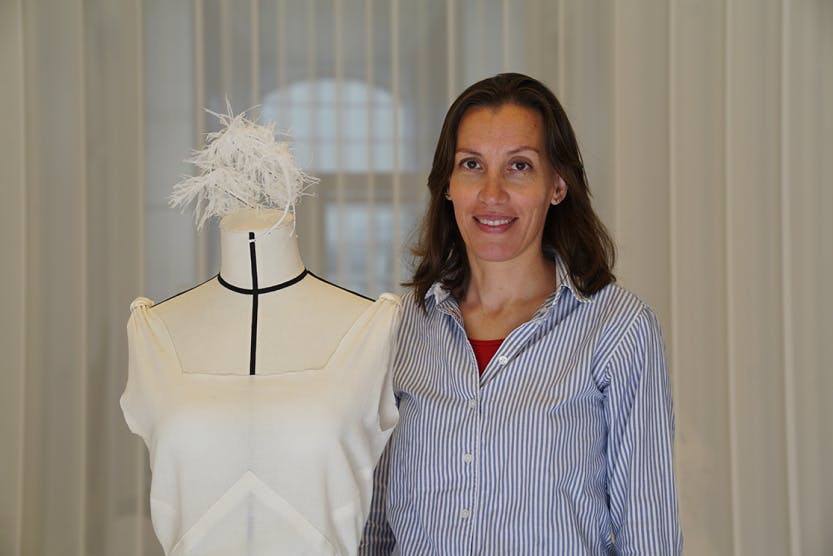 Mannequins displaying ivory toile dresses in an exhibition space